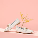 Women's moccasins in leather patent leather with ornament and low white heel